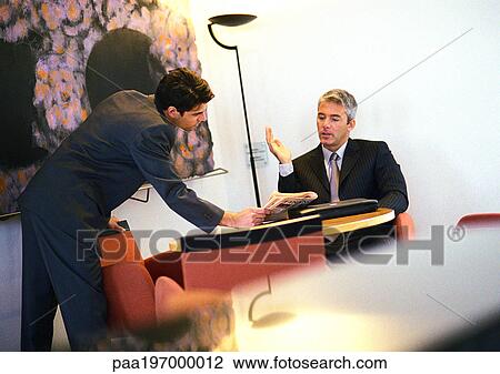 Businessmen talking to each other View Large Photo Image Stock Image - Businessmen talking to each other. Fotosearch