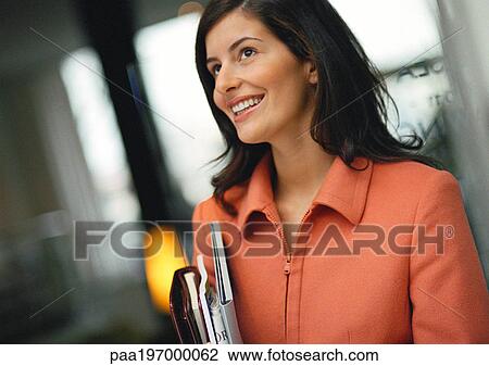 Businesswoman holding agenda and file, smiling. View Large Photo Image Stock Image - Businesswoman holding agenda and file, smiling.. Fotosearch