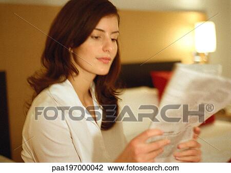 Businesswoman reading paper, head and shoulders, close-up, blurred View Large Photo Image Stock Image - Businesswoman reading paper, head and shoulders, close-up, blurred. Fotosearch
