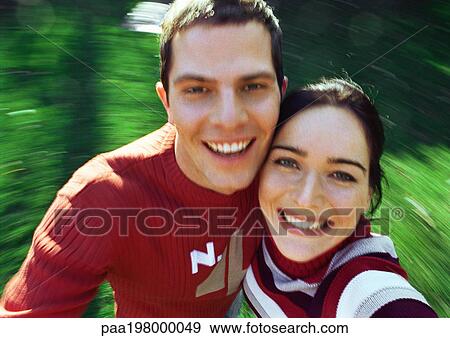 Man and woman smiling and looking up, background blurred View Large Photo Image Stock Photo - Man and woman smiling and looking up, background blurred. Fotosearch