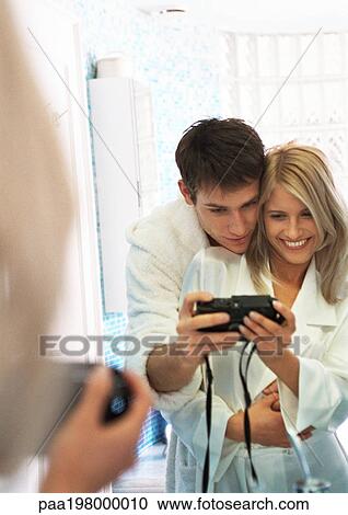 Man and woman taking photo of themselves in front of mirror View Large Photo Image Stock Image - Man and woman taking photo of themselves in front of mirror. Fotosearch