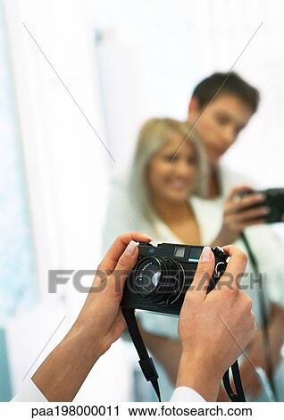 Man and woman taking photo of themselves in front of mirror View Large Photo Image Stock Image - Man and woman taking photo of themselves in front of mirror. Fotosearch