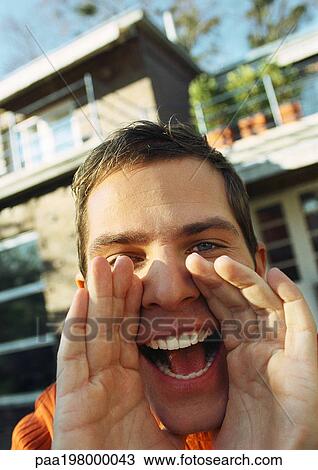 Man's hands around open mouth, close-up, house in background View Large Photo Image Stock Image - Man's hands around open mouth, close-up, house in background. Fotosearch