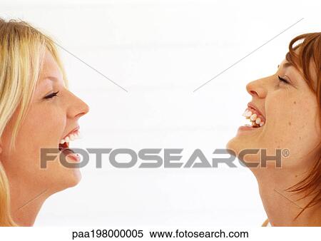 Two women laughing with heads back and eyes closed. View Large Photo Image Stock Photography - Two women laughing with heads back and eyes closed.. Fotosearch