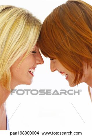 Two women touching foreheads and laughing View Large Photo Image Picture - Two women touching foreheads and laughing. Fotosearch