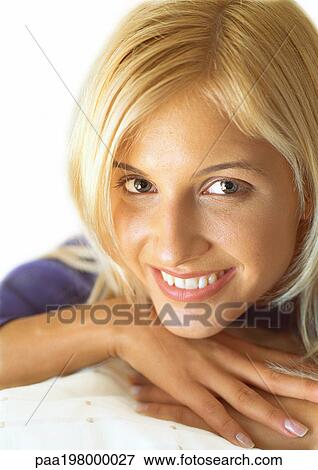 Woman's head resting on hands, smiling at camera, portrait, close-up View Large Photo Image Stock Photo - Woman's head resting on hands, smiling at camera, portrait, close-up. Fotosearch