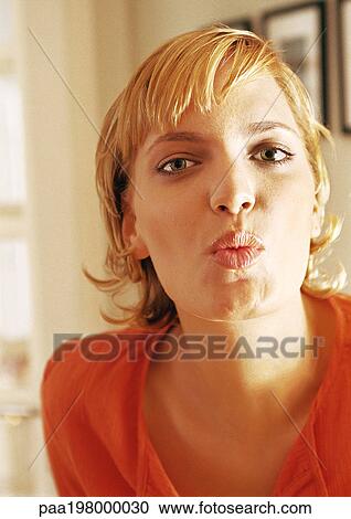 Young woman puckering lips, portrait View Large Photo Image Stock Image - Young woman puckering lips, portrait. Fotosearch