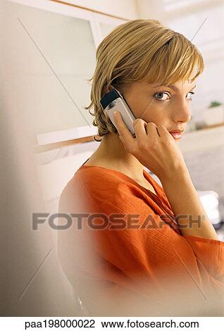 Young woman using cellphone, side view. View Large Photo Image Stock Image - Young woman using cellphone, side view.. Fotosearch