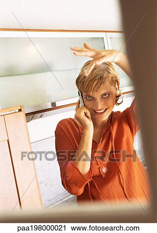 Young woman using cellphone with hand over her head. View Large Photo Image Stock Image - Young woman using cellphone with hand over her head.. Fotosearch