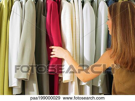 Girl in front of rack of suits, rear view View Large Photo Image Stock Photo - Girl in front of rack of suits, rear view. Fotosearch