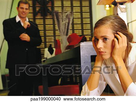 Woman holding head, man buttoning cuffs, in store. View Large Photo Image Stock Image - Woman holding head, man buttoning cuffs, in store.. Fotosearch