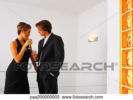 Man and woman drinking champagne and talking. View Large Photo Image Stock Image - Man and woman drinking champagne and talking.. Fotosearch