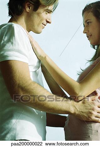 Stock Image - Man and woman holding each other.. Fotosearch