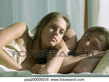 Man and woman in bed, woman leaning against man, close up. View Large Photo Image Stock Photograph - Man and woman in bed, woman leaning against man, close up.. Fotosearch