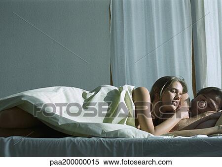 Man and woman in bed, woman leaning against man. View Large Photo Image Stock Photography - Man and woman in bed, woman leaning against man.. Fotosearch
