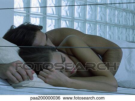 Man and woman lying in bed, man holding woman. View Large Photo Image Stock Photograph - Man and woman lying in bed, man holding woman.. Fotosearch
