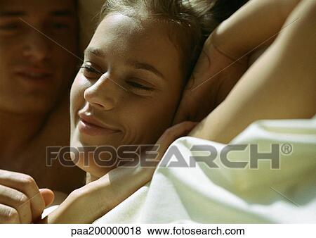 Man and woman lying next to each other, close up. View Large Photo Image Stock Photo - Man and woman lying next to each other, close up.. Fotosearch