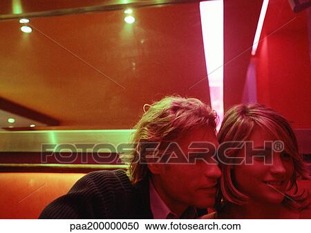 Stock Image - Man and woman sitting close together.. Fotosearch