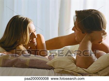 Man and woman talking in bed. View Large Photo Image Stock Photo - Man and woman talking in bed.. Fotosearch