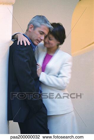 Man leaning against column, woman putting arm around him View Large Photo Image Stock Image - Man leaning against column, woman putting arm around him. Fotosearch
