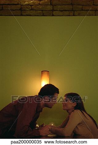 Man leaning forward in front of light to kiss a woman. View Large Photo Image Stock Photography - Man leaning forward in front of light to kiss a woman.. Fotosearch