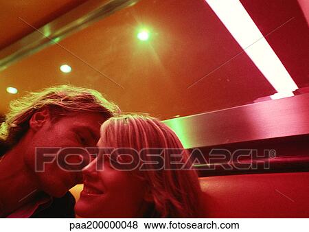 Man leaning to kiss woman's cheek. View Large Photo Image Stock Photo - Man leaning to kiss woman's cheek.. Fotosearch
