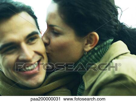 Woman kissing man on cheek, close up. View Large Photo Image Stock Image - Woman kissing man on cheek, close up.. Fotosearch