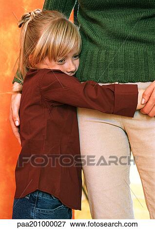 Daughter hugging mother around waist View Large Photo Image Stock Photo - Daughter hugging mother around waist. Fotosearch