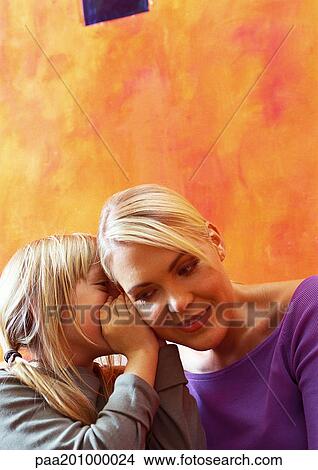 Daughter whispering to mother. View Large Photo Image Picture - Daughter whispering to mother.. Fotosearch