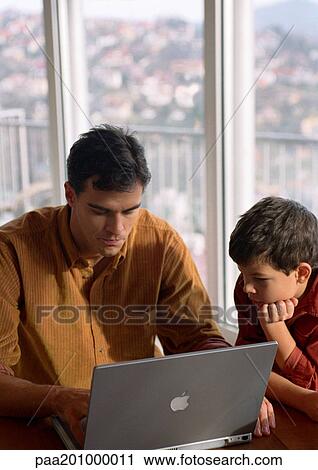 Father and son working on computer. View Large Photo Image Stock Image - Father and son working on computer.. Fotosearch