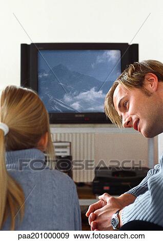 Father looking at daughter watching TV. View Large Photo Image Stock Photo - Father looking at daughter watching TV.. Fotosearch