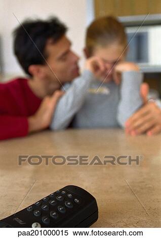 Remote control on table, father and daughter in background, blurred. View Large Photo Image Stock Photography - Remote control on table, father and daughter in background, blurred.. Fotosearch