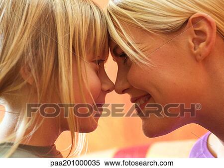 Young woman and little girl smiling with foreheads and noses touching, side view, close-up, head shot View Large Photo Image Stock Photography - Young woman and little girl smiling with foreheads and noses touching, side view, close-up, head shot. Fotosearch