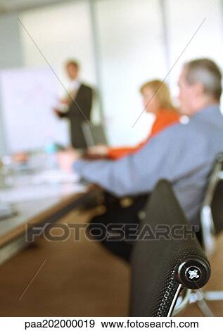 Stock Photo - Business people sitting in meeting, blurred. Fotosearch
