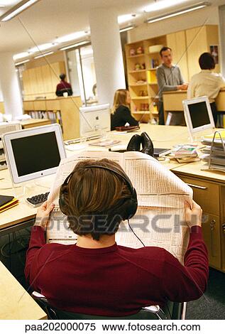 Businessman looking at paper in office, rear view. View Large Photo Image Stock Photography - Businessman looking at paper in office, rear view.. Fotosearch