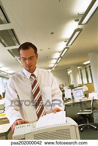 Businessman using copy machine. View Large Photo Image Stock Image - Businessman using copy machine.. Fotosearch
