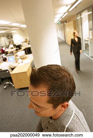 Businessman walking through office, view from above. View Large Photo Image Stock Photo - Businessman walking through office, view from above.. Fotosearch