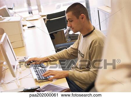 Businessman working on computer in office. View Large Photo Image Stock Image - Businessman working on computer in office.. Fotosearch