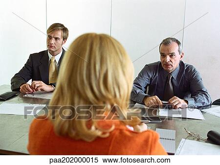 Businessmen and businesswoman sitting at table, woman's back to camera. View Large Photo Image Stock Photography - Businessmen and businesswoman sitting at table, woman's back to camera.. Fotosearch
