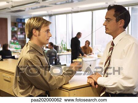 Businessmen talking in office. View Large Photo Image Stock Image - Businessmen talking in office.. Fotosearch