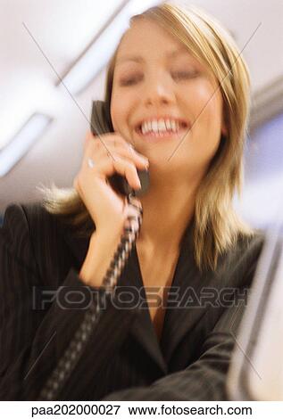 Businesswoman on phone smiling, blurred. View Large Photo Image Stock Photo - Businesswoman on phone smiling, blurred.. Fotosearch