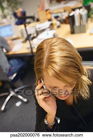 Businesswoman talking on cell phone, head bent down. View Large Photo Image Stock Photograph - Businesswoman talking on cell phone, head bent down.. Fotosearch