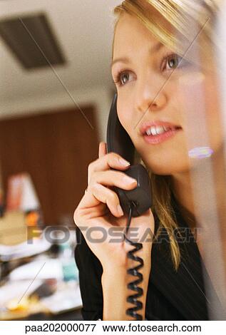 Stock Photo - Businesswoman talking on phone, close up portrait.. Fotosearch