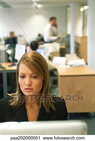 Stock Image - Businesswoman working on computer.. Fotosearch