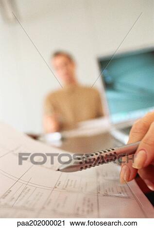 Pen and agenda, and businessman in the background, blurred. View Large Photo Image Stock Image - Pen and agenda, and businessman in the background, blurred.. Fotosearch