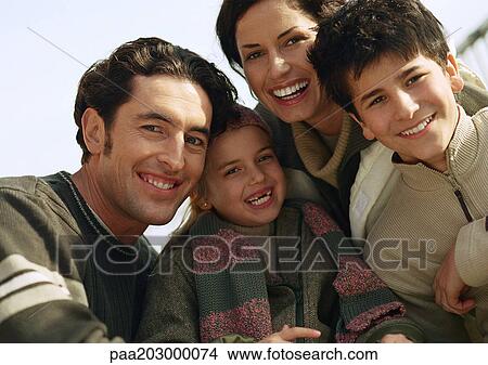 Picture - Adult man and woman with two children, head and shoulders, portrait, close up.. Fotosearch