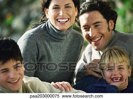 Adult man and woman with two children, head and shoulders, outside, close-up View Large Photo Image Stock Photography - Adult man and woman with two children, head and shoulders, outside, close-up. Fotosearch