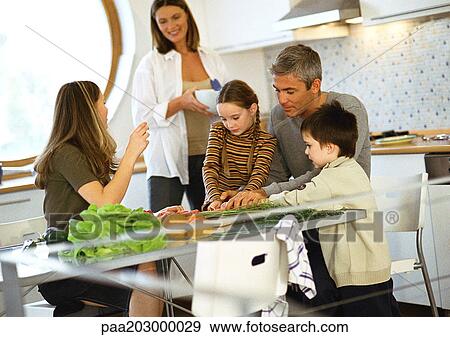 Stock Photo - Family in kitchen, portrait.. Fotosearch