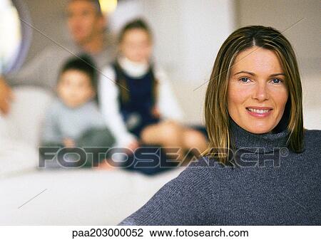 Family, mother in foreground, husband and two children blurred in background, close up. View Large Photo Image Stock Image - Family, mother in foreground, husband and two children blurred in background, close up.. Fotosearch