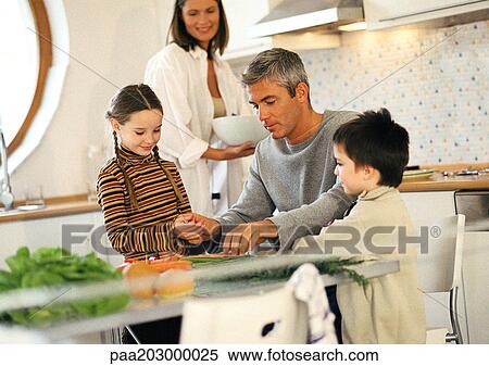 Family of four together in kitchen View Large Photo Image Stock Photography - Family of four together in kitchen. Fotosearch